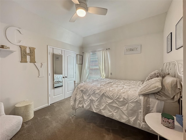 bedroom with a ceiling fan, baseboards, carpet floors, lofted ceiling, and a closet