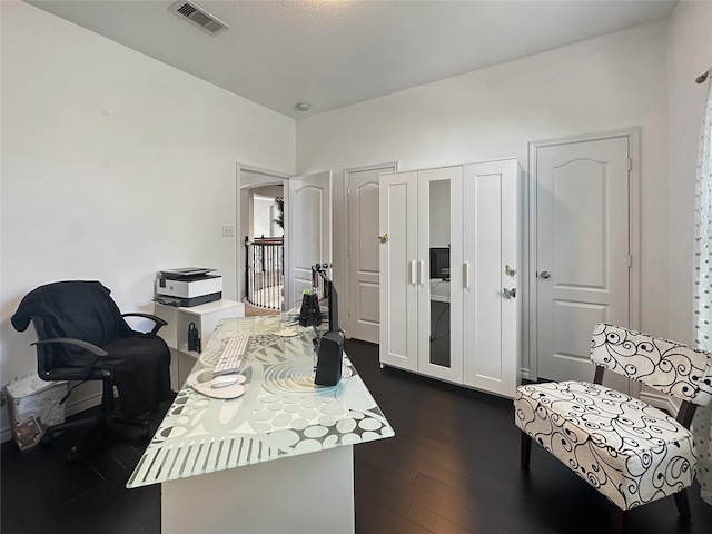 home office featuring visible vents and dark wood-type flooring