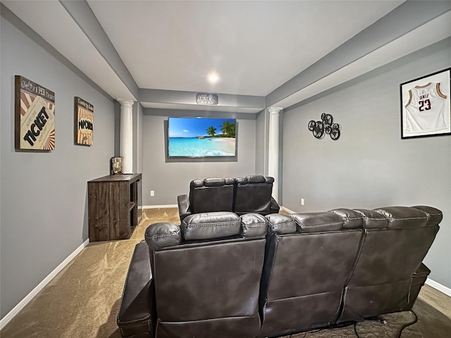 home theater featuring carpet flooring, baseboards, and ornate columns