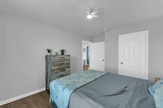 bedroom featuring a ceiling fan, baseboards, and dark wood-style flooring