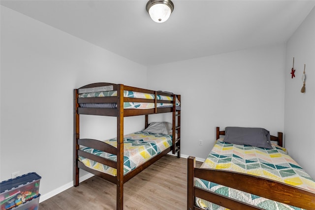 bedroom with baseboards and wood finished floors