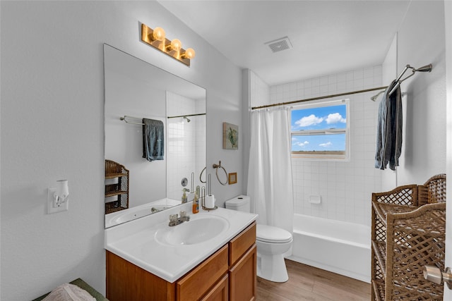 full bathroom featuring visible vents, toilet, shower / bath combo, wood finished floors, and vanity