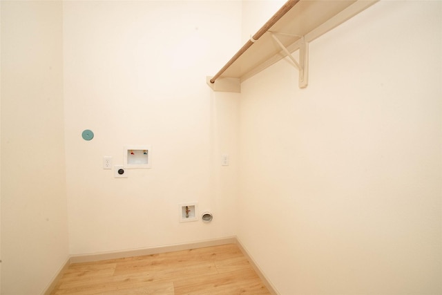 washroom featuring laundry area, light wood finished floors, baseboards, hookup for a washing machine, and electric dryer hookup