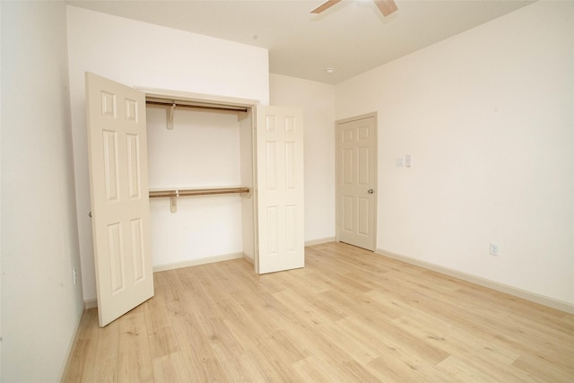 unfurnished bedroom with a ceiling fan, a closet, light wood-style flooring, and baseboards