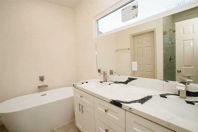 bathroom with double vanity, a stall shower, a soaking tub, tile patterned flooring, and a sink