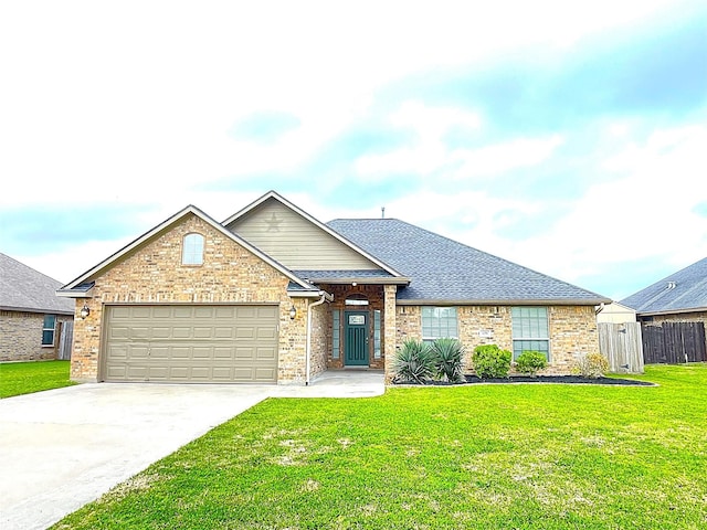 ranch-style home featuring brick siding, a shingled roof, concrete driveway, an attached garage, and a front yard