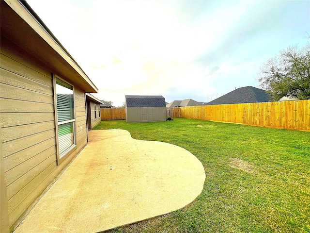 view of yard featuring a storage shed, a fenced backyard, a patio, and an outbuilding