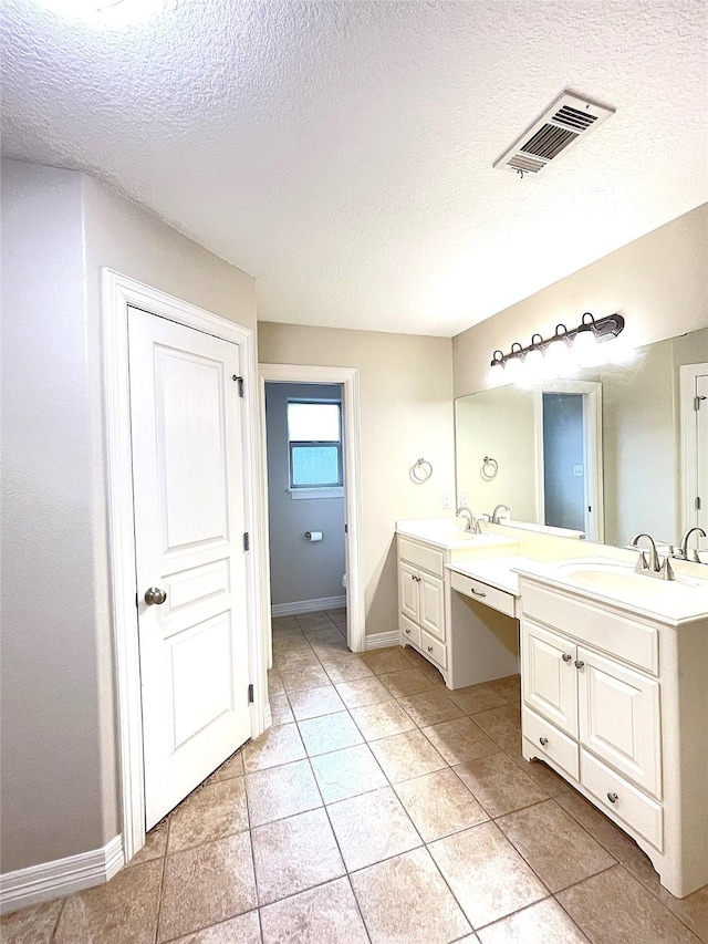 full bathroom featuring double vanity, baseboards, visible vents, toilet, and a sink