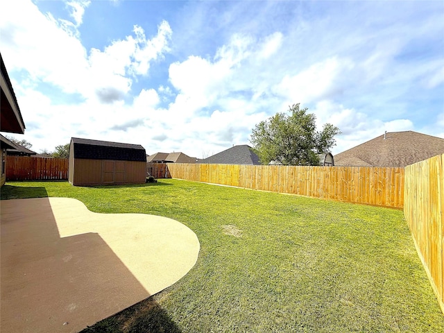 view of yard with a storage shed, a patio, an outbuilding, and a fenced backyard