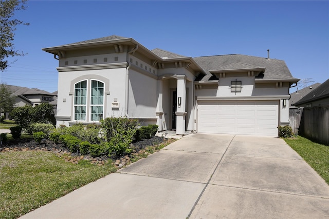 view of front of property with concrete driveway, a front lawn, fence, stucco siding, and roof with shingles