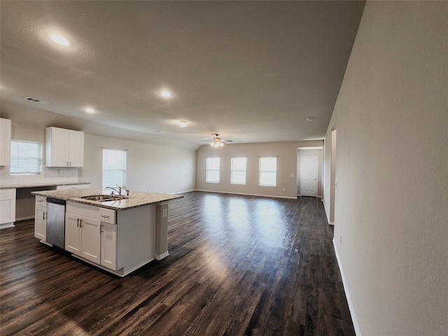 kitchen featuring dark wood finished floors, white cabinetry, a sink, plenty of natural light, and dishwasher