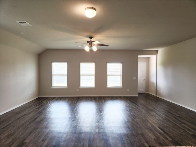 unfurnished room with visible vents, baseboards, and dark wood-type flooring