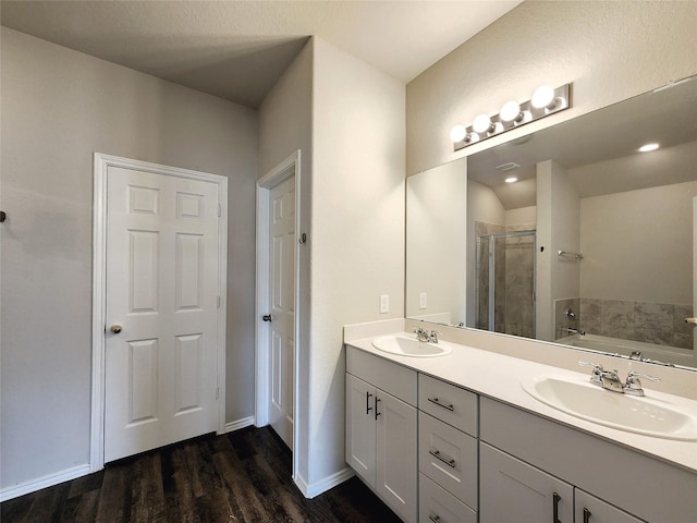 full bath with a garden tub, a shower stall, a sink, and wood finished floors