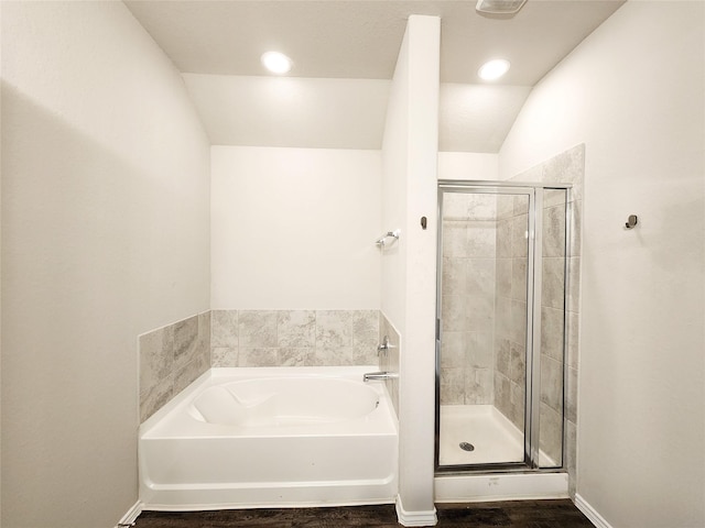 bathroom featuring a shower stall, baseboards, a bath, and recessed lighting