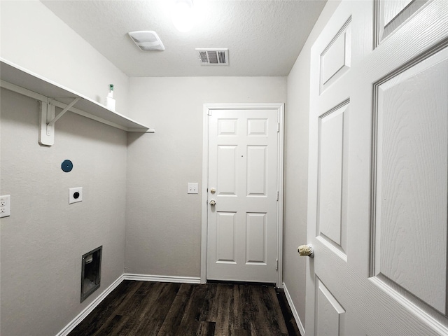 clothes washing area featuring dark wood-style floors, visible vents, electric dryer hookup, laundry area, and baseboards