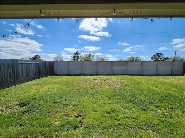 view of yard with a fenced backyard