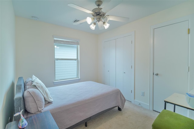 carpeted bedroom featuring visible vents and a ceiling fan