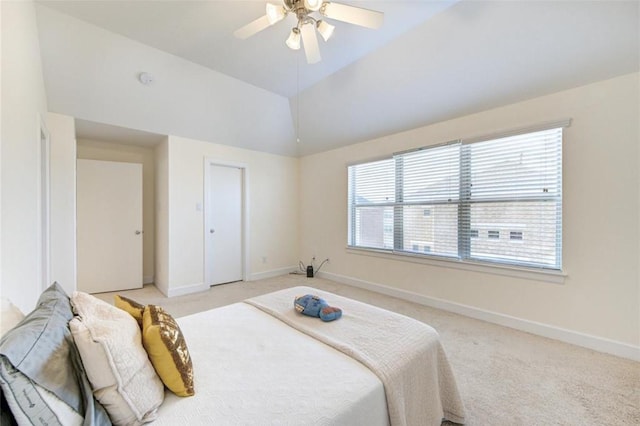 bedroom with baseboards, light colored carpet, and vaulted ceiling