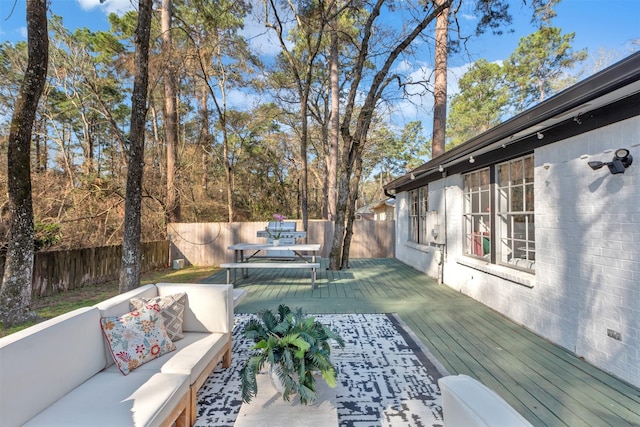 deck featuring an outdoor hangout area and a fenced backyard