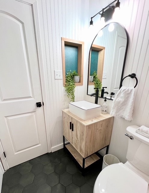 bathroom with vanity, tile patterned floors, and toilet