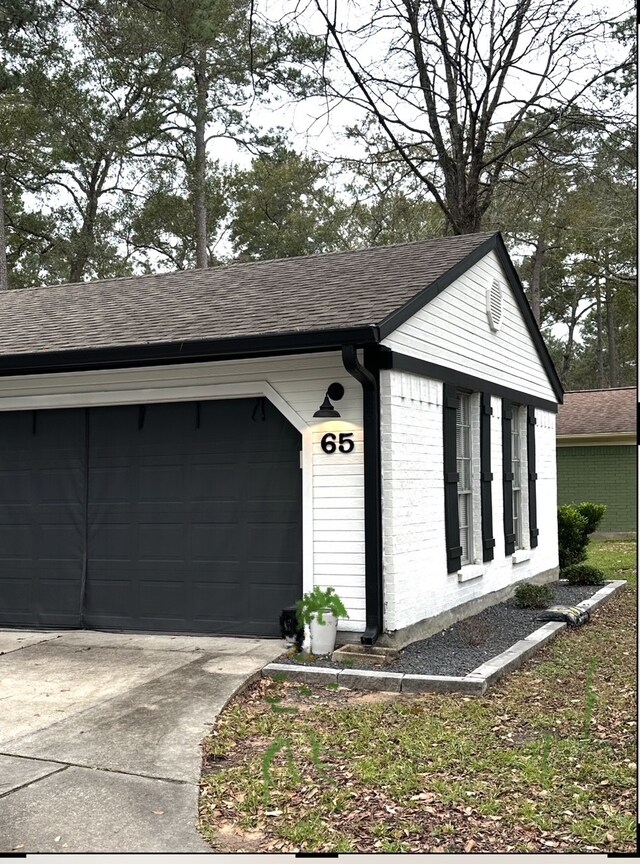 garage with concrete driveway