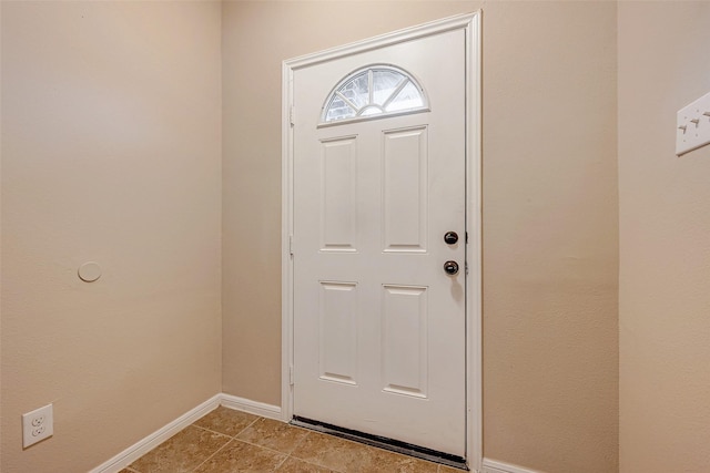 entryway with light tile patterned floors and baseboards