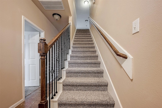 stairs featuring visible vents and baseboards