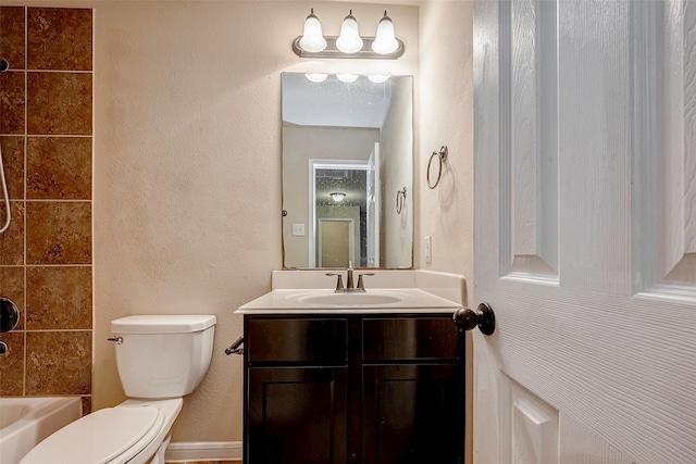 full bathroom featuring a textured wall, shower / tub combination, vanity, and toilet