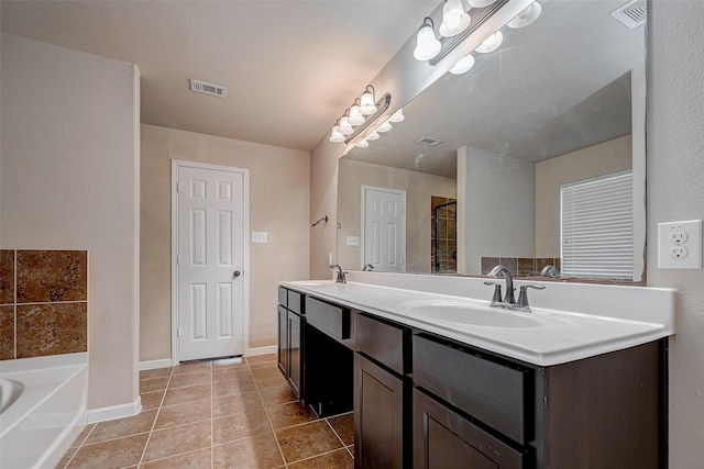 bathroom with visible vents, a sink, and tile patterned floors