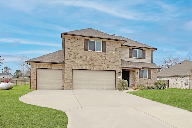 traditional home with driveway, roof with shingles, fence, a front yard, and brick siding