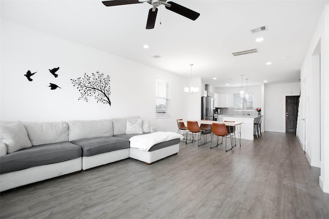 living area featuring wood finished floors, visible vents, and recessed lighting