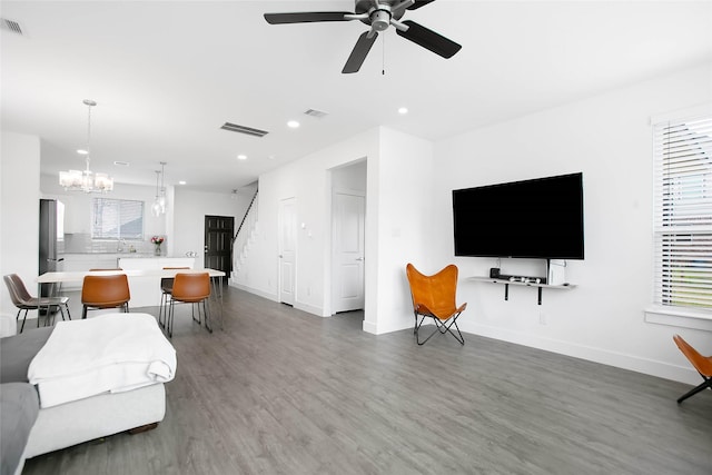 living area featuring recessed lighting, wood finished floors, visible vents, and a healthy amount of sunlight