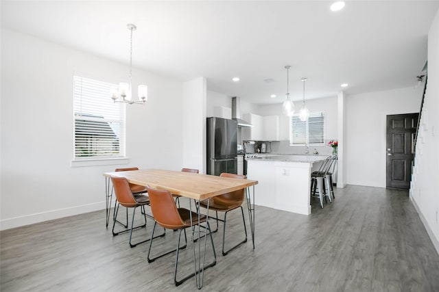 dining area with baseboards, recessed lighting, and light wood-style floors