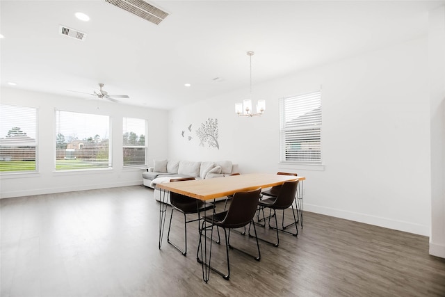 dining area featuring visible vents, baseboards, and wood finished floors