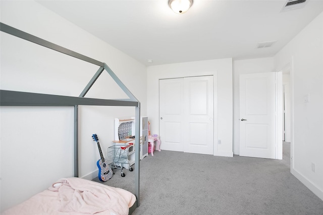 bedroom featuring carpet, a closet, visible vents, and baseboards