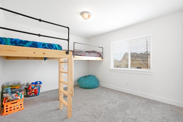 carpeted bedroom with baseboards