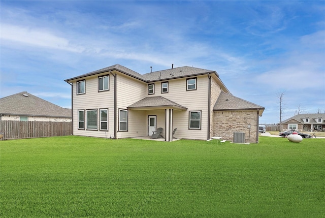 rear view of property with a patio, a shingled roof, a lawn, fence, and cooling unit