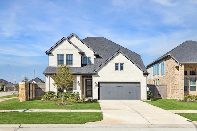 view of front of property with a front yard, brick siding, driveway, and fence