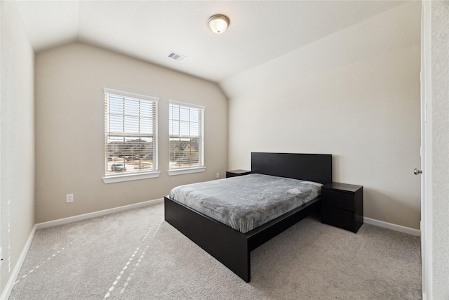 carpeted bedroom with lofted ceiling, visible vents, and baseboards