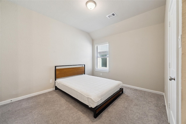 bedroom featuring carpet floors, visible vents, vaulted ceiling, and baseboards