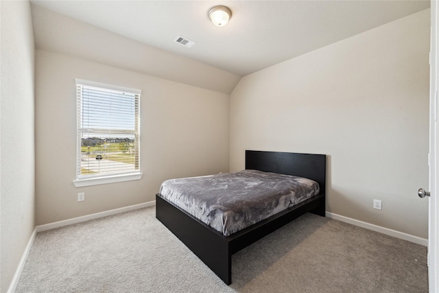 bedroom featuring lofted ceiling, carpet floors, visible vents, and baseboards