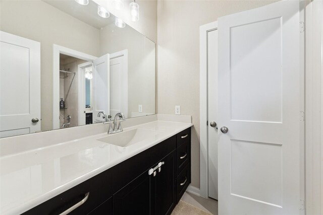 bathroom with a shower and vanity