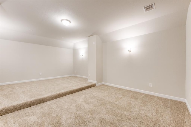 empty room with light carpet, baseboards, and visible vents