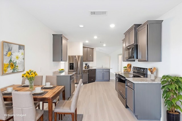 kitchen featuring black electric range, stainless steel refrigerator with ice dispenser, visible vents, a sink, and dishwashing machine