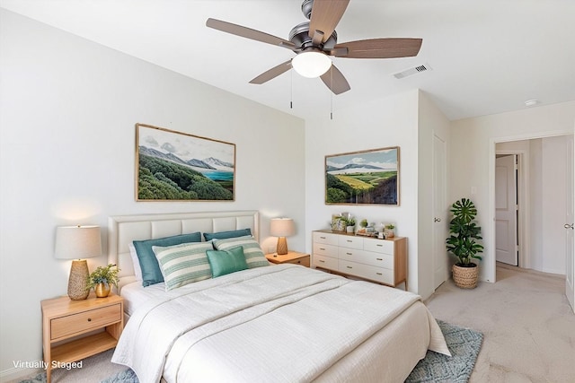 bedroom featuring visible vents, ceiling fan, and light carpet