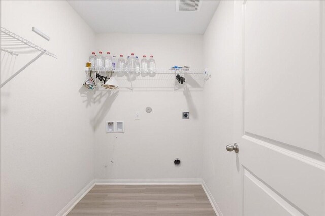 washroom featuring hookup for a washing machine, visible vents, light wood-style floors, electric dryer hookup, and laundry area