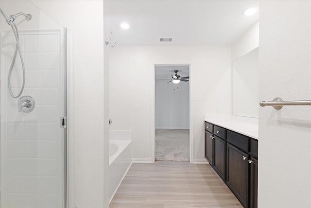 full bath with a shower, visible vents, vanity, wood finished floors, and a bath