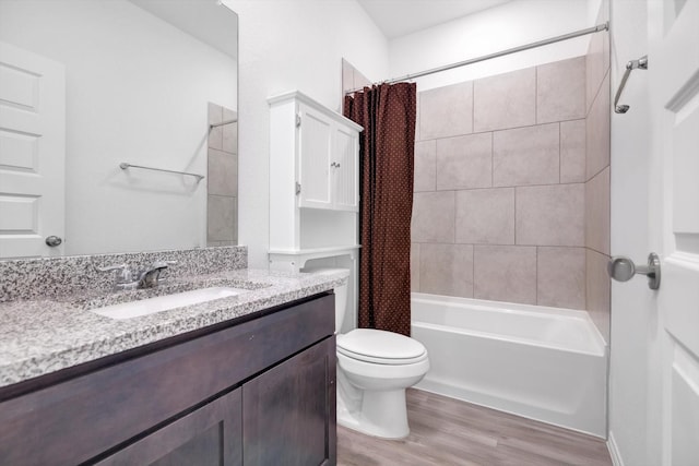 bathroom with vanity, shower / bath combo, wood finished floors, and toilet