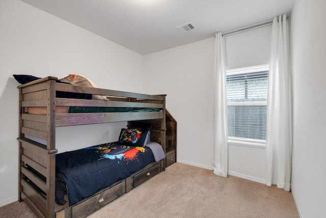 carpeted bedroom featuring visible vents and baseboards