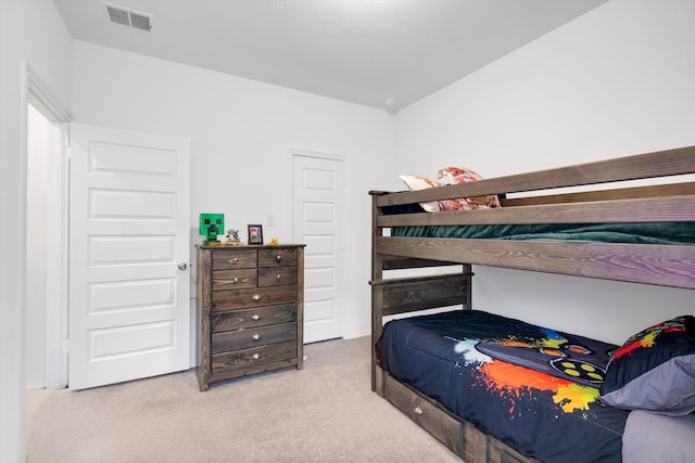 carpeted bedroom featuring visible vents